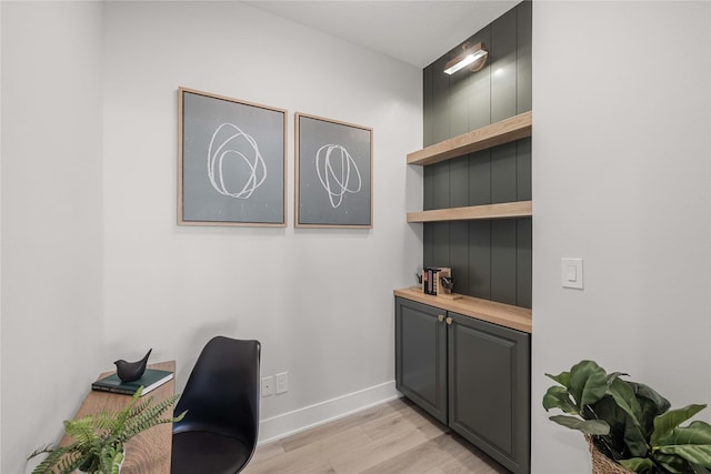 office area featuring baseboards and light wood-style flooring