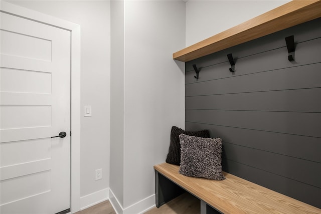 mudroom featuring light wood-style floors and baseboards