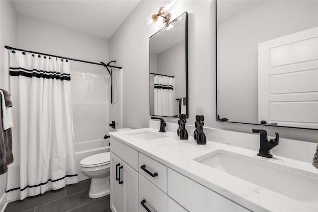full bathroom with a sink, tile patterned flooring, toilet, and double vanity