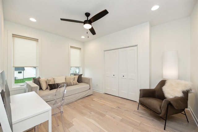 living area with recessed lighting, a ceiling fan, and light wood finished floors