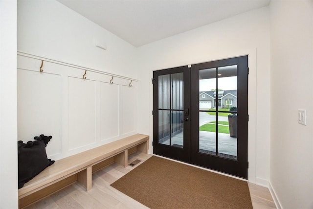 mudroom featuring visible vents, french doors, and wood finished floors