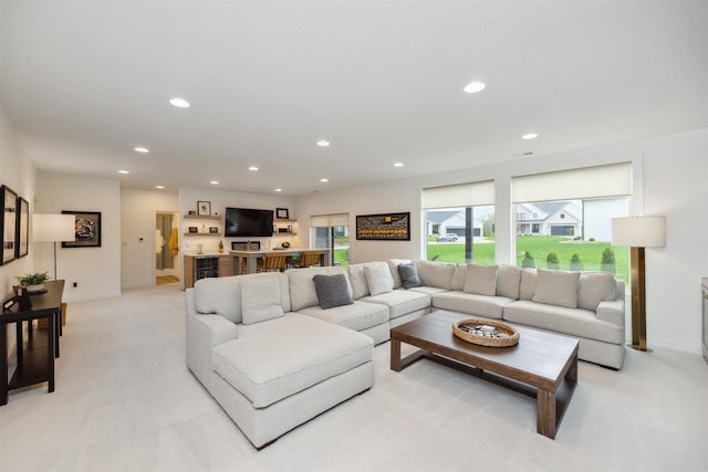 living area featuring recessed lighting and light carpet