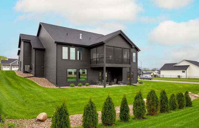 rear view of property with a lawn, fence, a sunroom, and a patio
