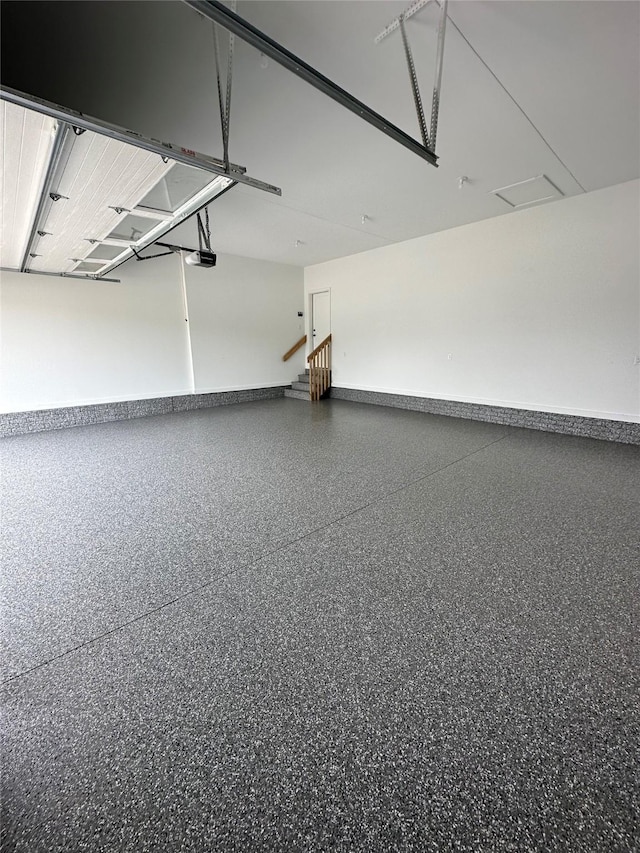 garage featuring baseboards and a garage door opener