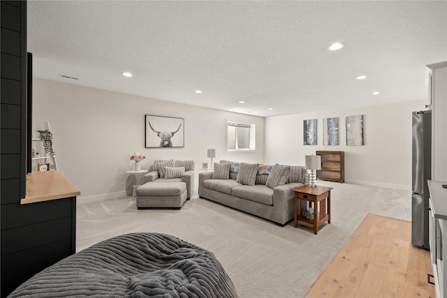3319 NE 8th St, Ankeny, IA 50021 - living area with recessed lighting, baseboards, a textured ceiling, and light wood-style floors