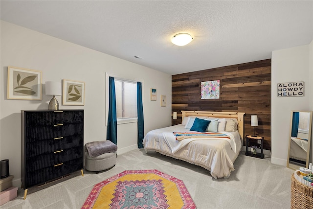 3319 NE 8th St, Ankeny, IA 50021 - carpeted bedroom with visible vents, wood walls, an accent wall, baseboards, and a textured ceiling