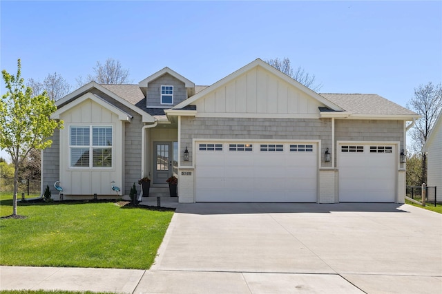 3319 NE 8th St, Ankeny, IA 50021 - view of front facade with roof with shingles, a garage, board and batten siding, a front yard, and driveway