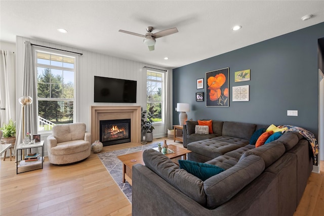 3319 NE 8th St, Ankeny, IA 50021 - living area with wood-type flooring, a ceiling fan, an accent wall, and recessed lighting