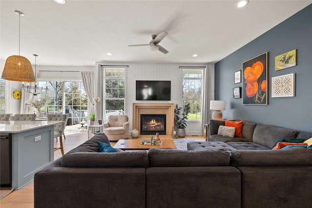 3319 NE 8th St, Ankeny, IA 50021 - living room featuring recessed lighting, a ceiling fan, light wood finished floors, and a glass covered fireplace