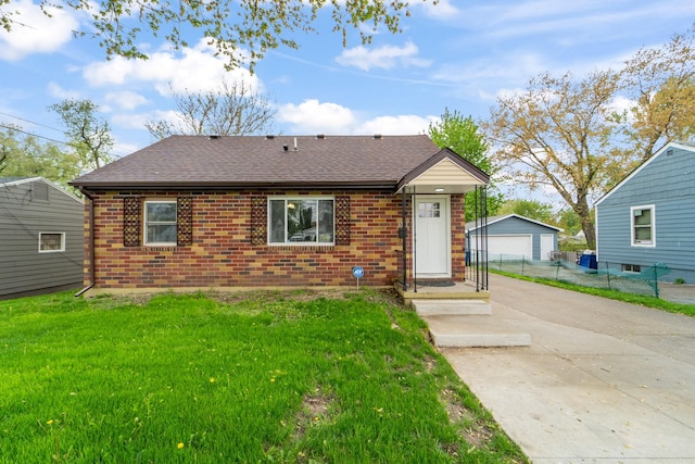 back of property featuring brick siding, roof with shingles, and a garage