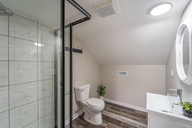 bathroom with toilet, a textured ceiling, visible vents, and lofted ceiling