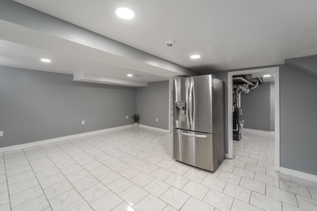 finished below grade area with stainless steel fridge with ice dispenser, baseboards, and recessed lighting