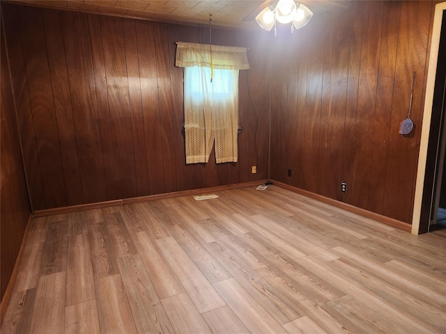709 S Streeter St, Knoxville, IA 50138 - empty room featuring wood walls, wood finished floors, and visible vents