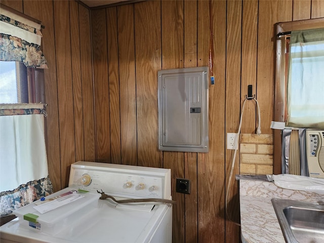 709 S Streeter St, Knoxville, IA 50138 - laundry area featuring wooden walls, laundry area, a sink, washer / clothes dryer, and electric panel