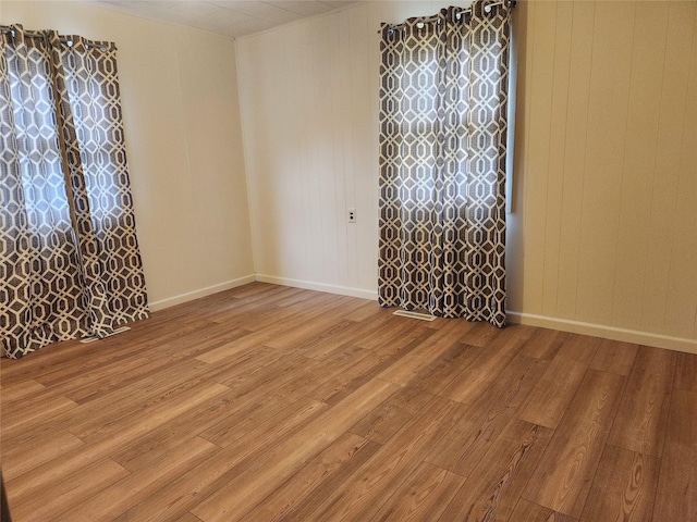 709 S Streeter St, Knoxville, IA 50138 - spare room featuring baseboards and wood finished floors