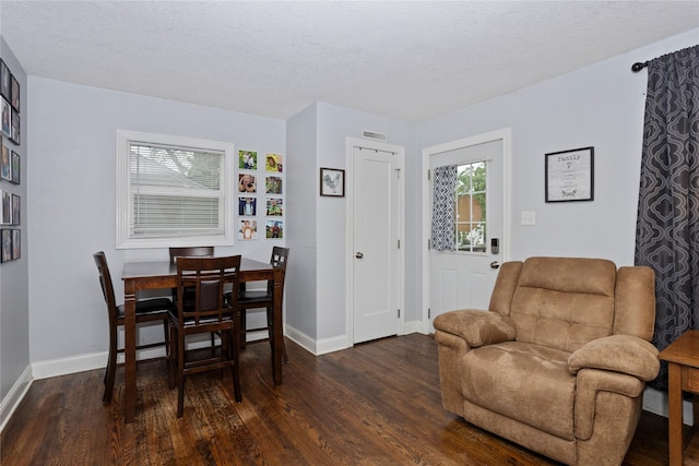 3924 55th St, Des Moines, IA 50310 - dining space featuring wood finished floors, plenty of natural light, baseboards, and a textured ceiling