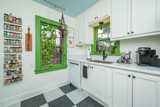 kitchen with a sink, white cabinetry, and dishwasher