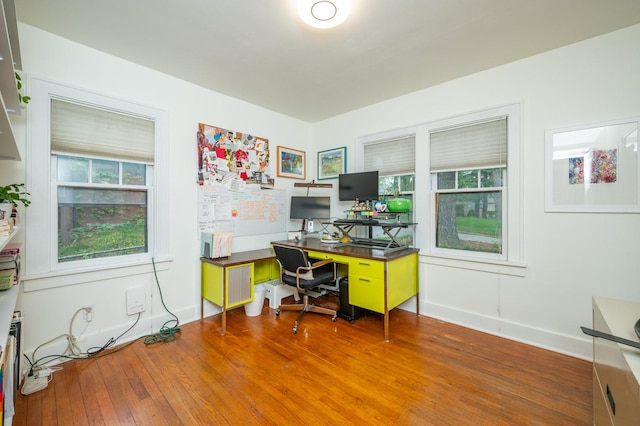 home office featuring baseboards and wood finished floors