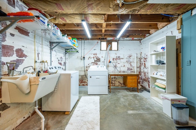 basement featuring a sink and separate washer and dryer