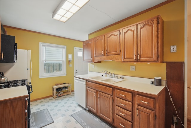 4131 Cornell St, Des Moines, IA 50313 - kitchen featuring dishwasher, a sink, gas stove, light countertops, and light floors
