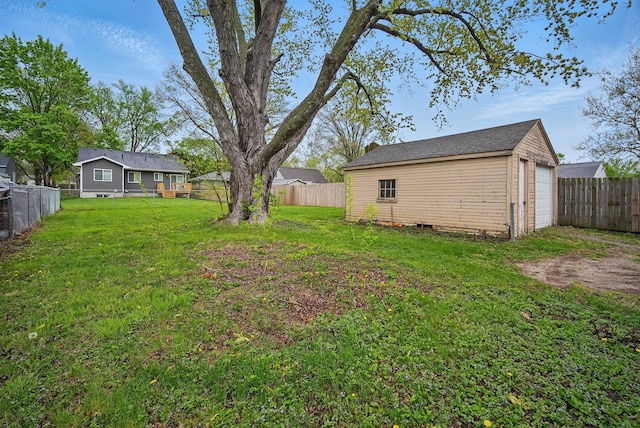 4131 Cornell St, Des Moines, IA 50313 - view of yard featuring a fenced backyard, an outbuilding, and a garage