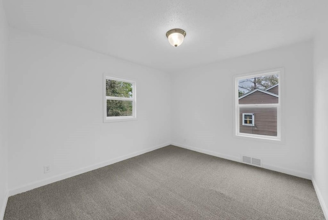 4038 57th St, Des Moines, IA 50310 - carpeted spare room with baseboards and visible vents