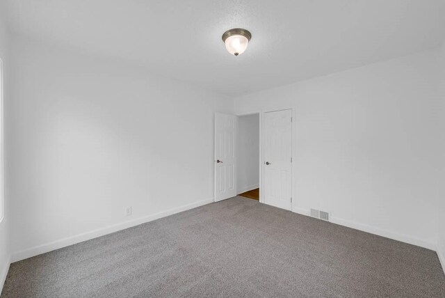4038 57th St, Des Moines, IA 50310 - carpeted spare room with baseboards and visible vents