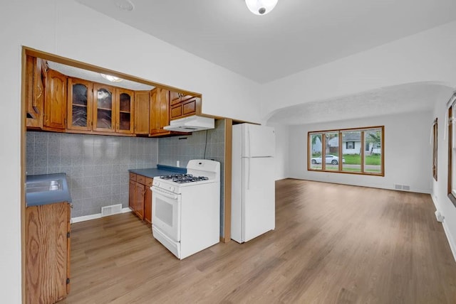 4038 57th St, Des Moines, IA 50310 - kitchen featuring visible vents, under cabinet range hood, brown cabinets, and white appliances