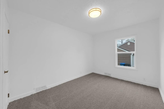 4038 57th St, Des Moines, IA 50310 - carpeted empty room with baseboards and visible vents