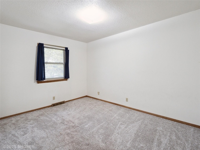 4508 SE 3rd St, Des Moines, IA 50315 - carpeted spare room featuring a textured ceiling, visible vents, and baseboards