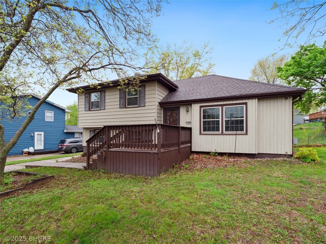 4508 SE 3rd St, Des Moines, IA 50315 - rear view of house with a lawn, roof with shingles, and a wooden deck