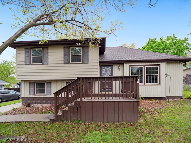4508 SE 3rd St, Des Moines, IA 50315 - split level home featuring roof with shingles and a wooden deck