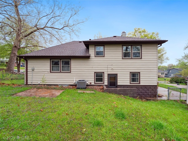 4508 SE 3rd St, Des Moines, IA 50315 - back of property with fence, a yard, a chimney, and cooling unit