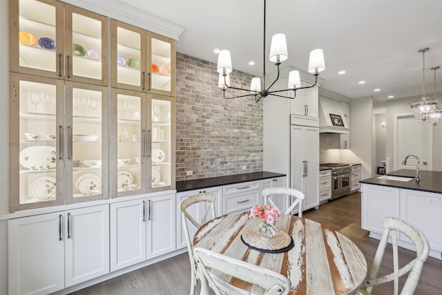 dining room featuring recessed lighting, an inviting chandelier, and dark wood-type flooring