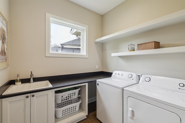 laundry area with a sink, cabinet space, and independent washer and dryer