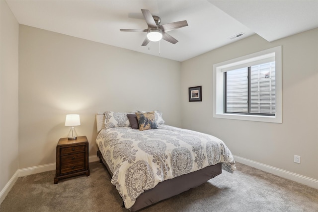 carpeted bedroom with baseboards, ceiling fan, and visible vents