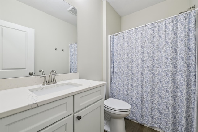 73 Myles Ct, Waukee, IA 50263 - full bathroom with vanity, toilet, visible vents, and wood finished floors