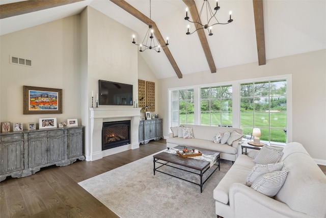 73 Myles Ct, Waukee, IA 50263 - living room with a warm lit fireplace, an inviting chandelier, visible vents, high vaulted ceiling, and wood finished floors