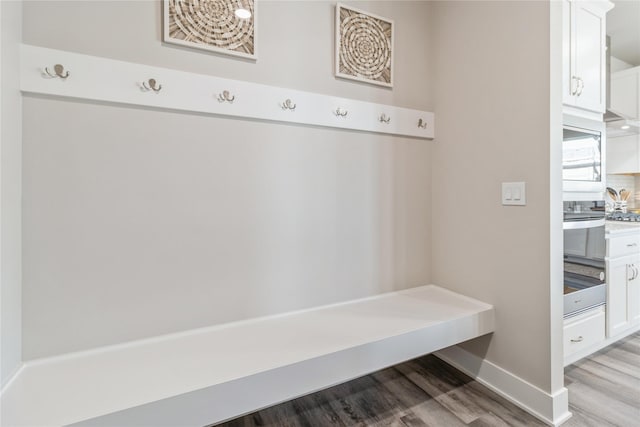 mudroom with light wood-style floors and baseboards