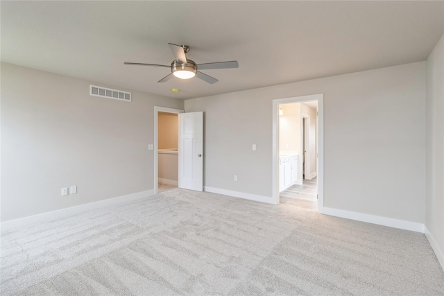 unfurnished bedroom with baseboards, light carpet, a ceiling fan, and visible vents