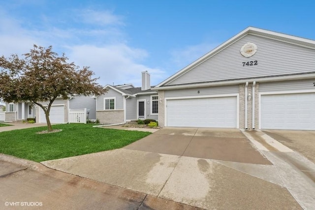 7422 SE 23rd St Unit 6, Des Moines, IA 50320 - view of front facade with an attached garage, concrete driveway, brick siding, and a front yard