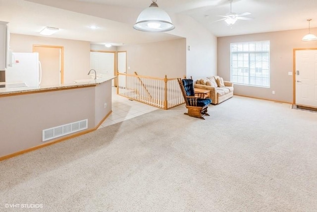 7422 SE 23rd St Unit 6, Des Moines, IA 50320 - unfurnished room with visible vents, a ceiling fan, baseboards, and light carpet