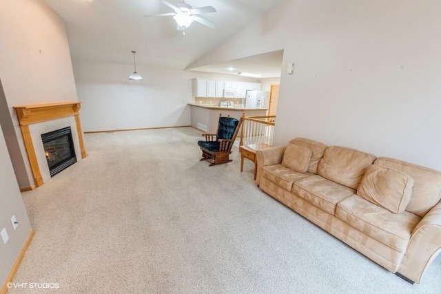 7422 SE 23rd St Unit 6, Des Moines, IA 50320 - living room featuring a glass covered fireplace, carpet, a ceiling fan, baseboards, and lofted ceiling
