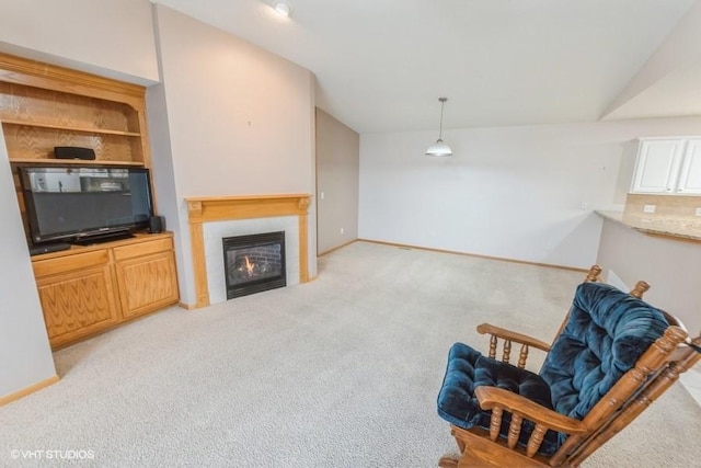 7422 SE 23rd St Unit 6, Des Moines, IA 50320 - carpeted living area with baseboards, vaulted ceiling, and a tiled fireplace