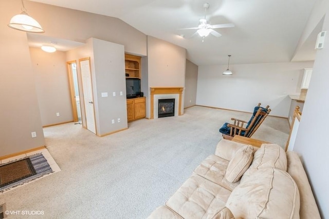 7422 SE 23rd St Unit 6, Des Moines, IA 50320 - living room with a lit fireplace, light colored carpet, vaulted ceiling, and a ceiling fan
