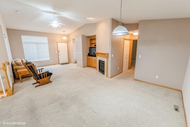 7422 SE 23rd St Unit 6, Des Moines, IA 50320 - living area featuring baseboards, a ceiling fan, vaulted ceiling, and light carpet