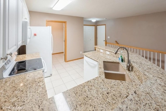7422 SE 23rd St Unit 6, Des Moines, IA 50320 - kitchen with white appliances, light stone countertops, white cabinetry, a sink, and light tile patterned floors