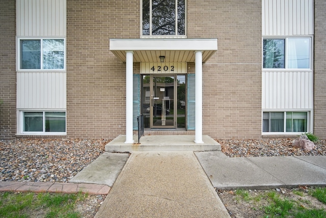 4202 62nd St Unit 6, Urbandale, IA 50322 - property entrance featuring brick siding
