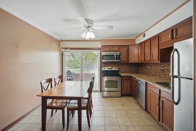 4202 62nd St Unit 6, Urbandale, IA 50322 - kitchen featuring ceiling fan, appliances with stainless steel finishes, light tile patterned floors, tasteful backsplash, and visible vents