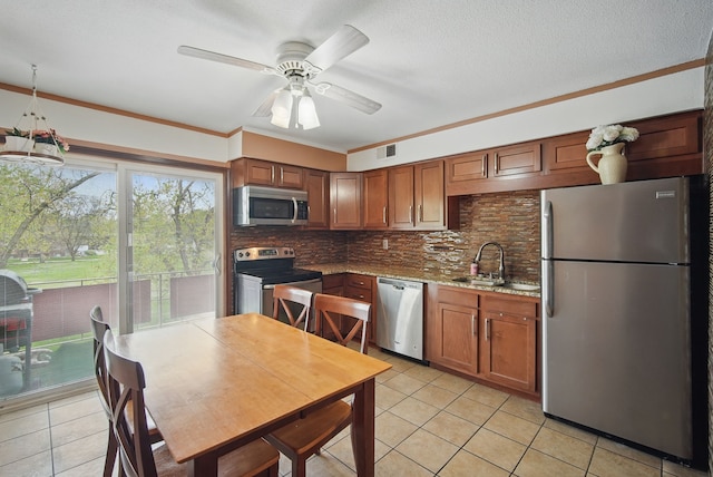 4202 62nd St Unit 6, Urbandale, IA 50322 - kitchen featuring crown molding, a sink, stainless steel appliances, light tile patterned floors, and backsplash